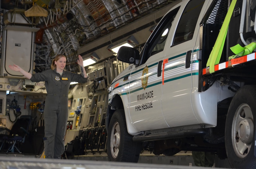 Airman 1st Class Hope Harr, a C-17 loadmaster with the 437th Airlift Wing, Joint Base Charleston, S.C., assists with the loading of a Miami-Dade Fire Rescue truck March 9, 2017.