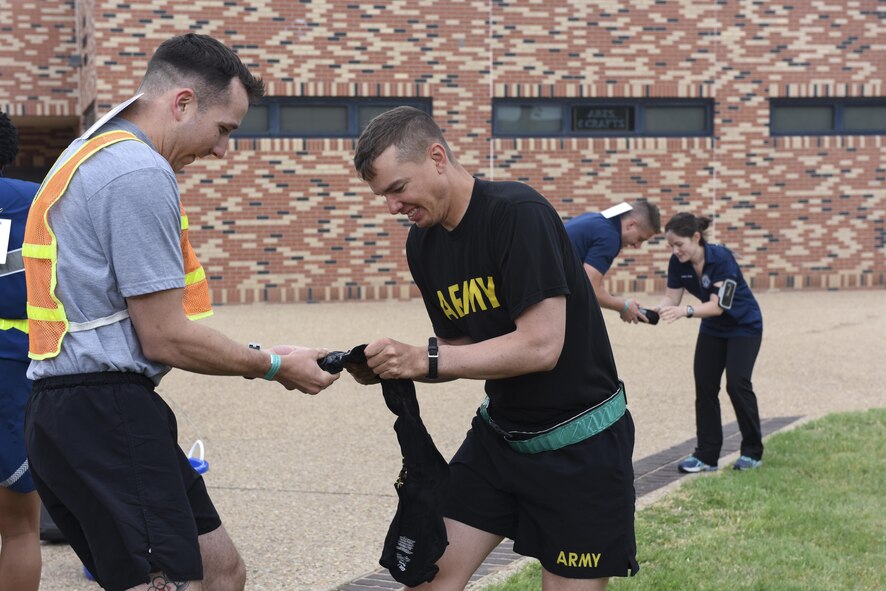 Competitors attempt to unfold frozen T-shirts at the 7th annual Sexual Assault Response Coordinator Challenge on Goodfellow Air Force Base, Texas, April 14, 2017. The challenge raised awareness of sexual assault prevention and response through engaging participants in games and riddles. (U.S. Air Force photo by Airman 1st Class Chase Sousa/Released)