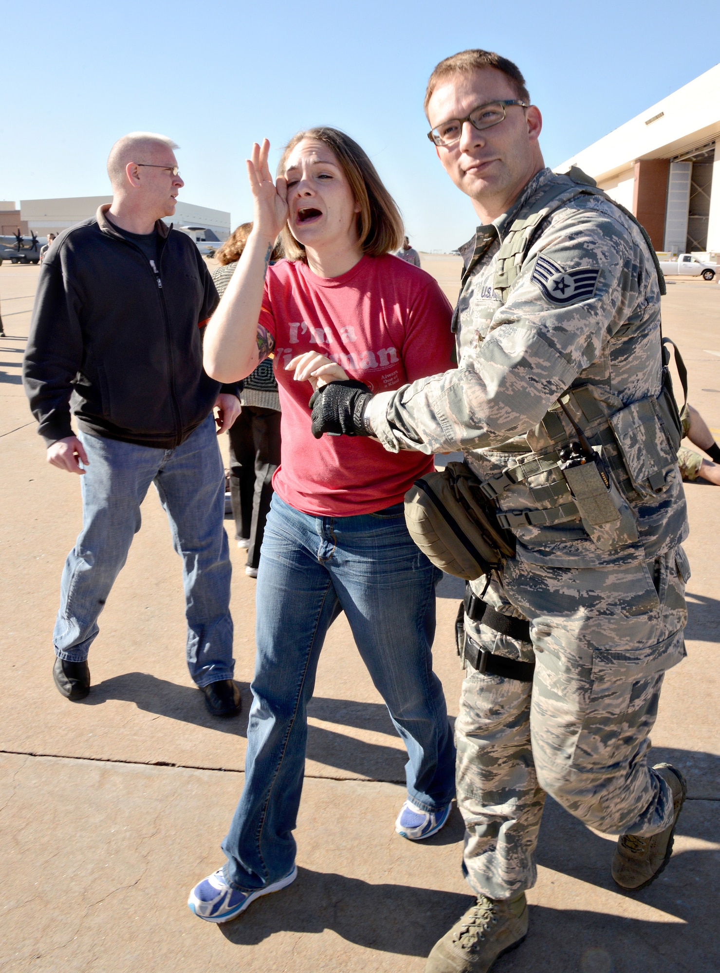 Staff Sgt. Brett Jones, with the 72nd Security Forces Squadron, assists volunteer actor, Master Sgt. Jo DeLorenzi as she looks for her children during the emergency response exercise April 6. (Air Force photo by Kelly White)