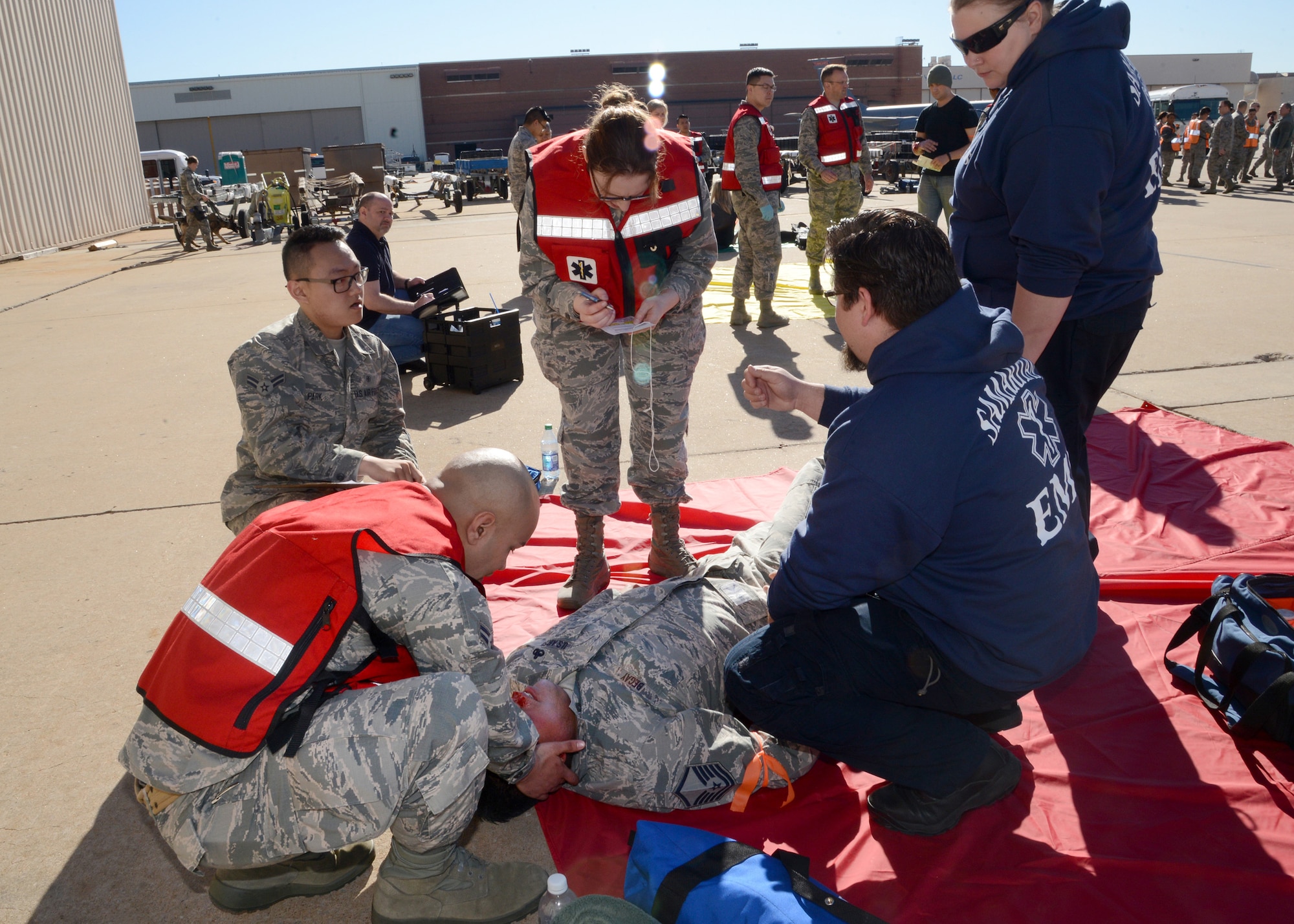 Members of the 72nd Medical Group worked side-by-side with Samaritan EMS during the emergency response exercise April 6 to help Master Sgt. Bob Begay, with the 513th Maintenance Squadron. Moulage victims were sorted into four categories (minor, delayed, immediate and morgue) based on injury severity in the triage area. Medics gave immediate care to the victims and filled out individual triage tags, which shows such information as personal information about the victim, types of injuries, vital signs and mental state. The triage tags help inform EMS or other medical professionals about a victim’s state when they enter their care. (Air Force photo by Kelly White)