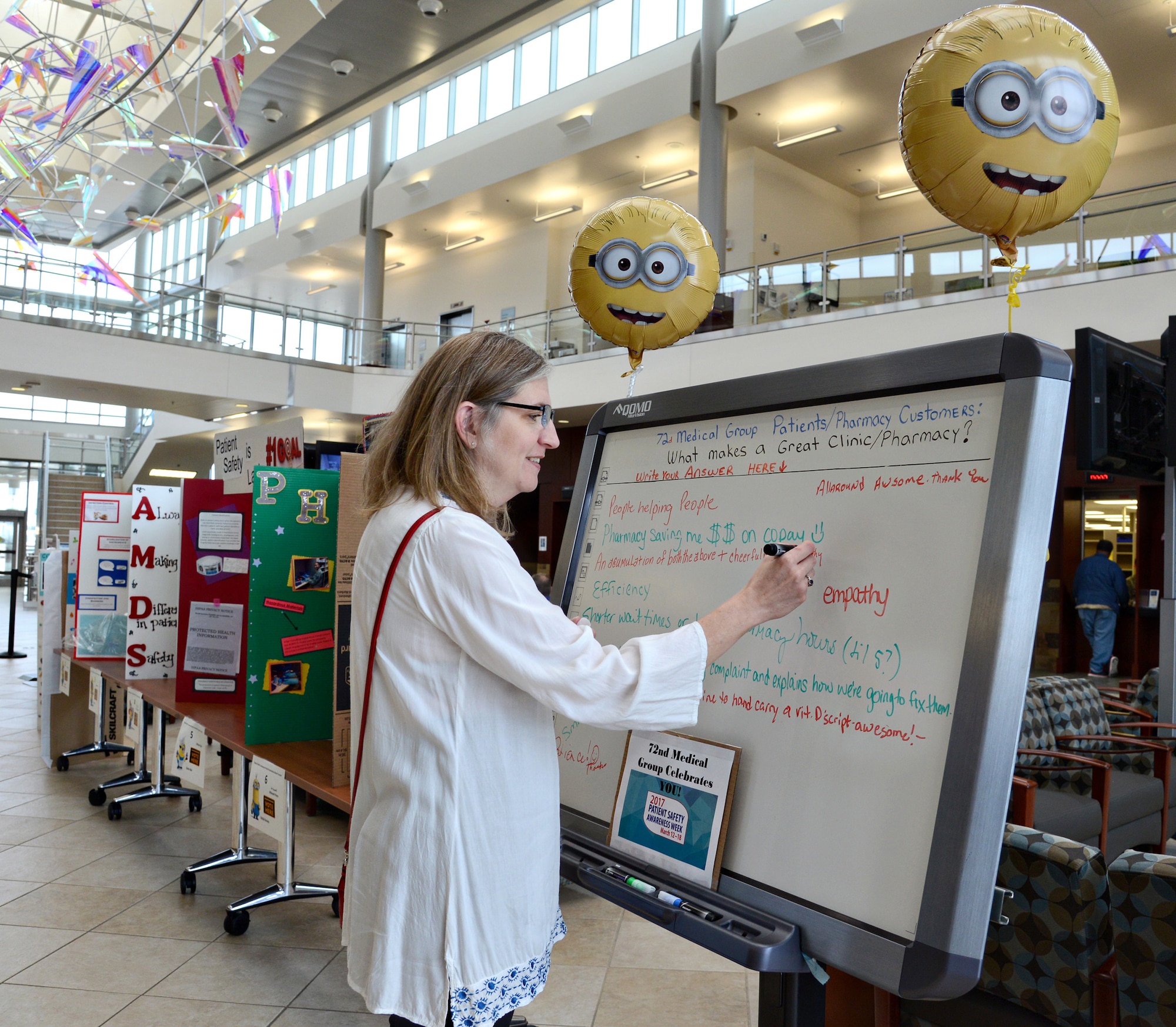 Susan Nelson, a customer at the Tinker Clinic, writes a comment on a board in the Medical Group atrium during Patient Safety Awareness Week. The comment boards for patients and staff members were one of several activities highlighting the week’s theme, “United for Patient Safety.” (Air Force photo by Kelly White)