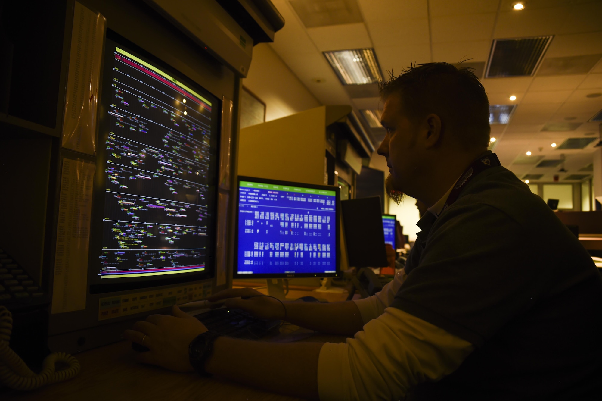 Brian Honor, 22nd Space Operations Squadron satellite network scheduler, monitors the schedule for the Air Force Satellite Control Network using the electronic scheduling dissemination at Schriever Air Force Base, Colorado, Wednesday, April 5, 2017. The network is a system of antennas from all over the world that provide time and link for the users to their satellites. (U.S. Air Force photo/Tech. Sgt. Julius Delos Reyes)