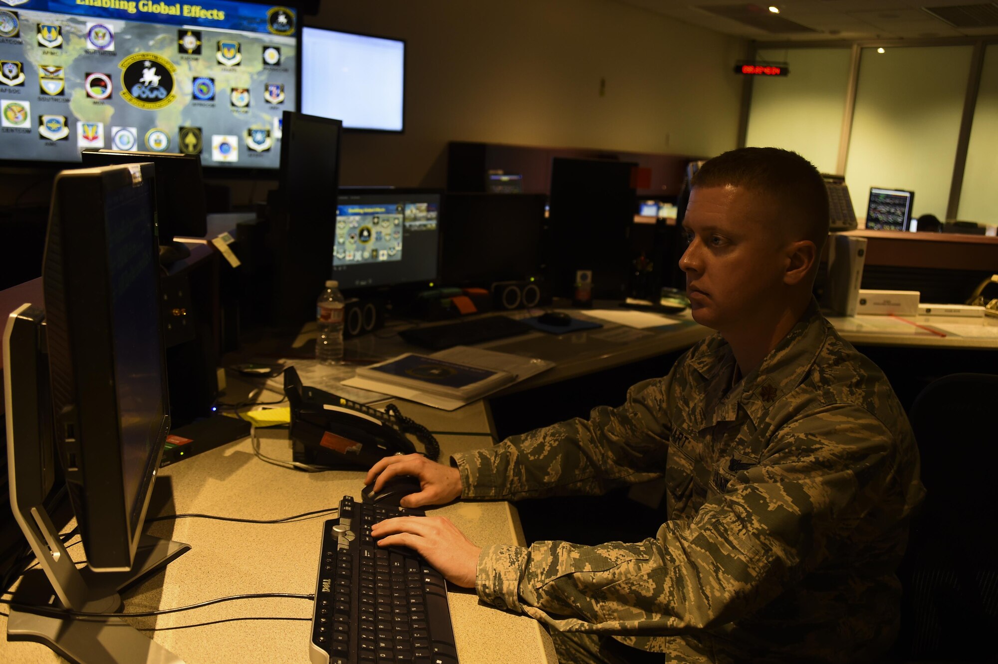 Maj. Gregory Stewart, 22nd Space Operations Squadron mission commander, supervises the Air Force Satellite Control Network schedulers at Schriever Air Force Base, Colorado, Wednesday, April 5, 2017. The schedulers provide support to 50th Space Wing units, several Air Force Space Command missions as well as other government agencies, such as NASA and National Oceanic and Atmospheric Administration. (U.S. Air Force photo/Tech. Sgt. Julius Delos Reyes)