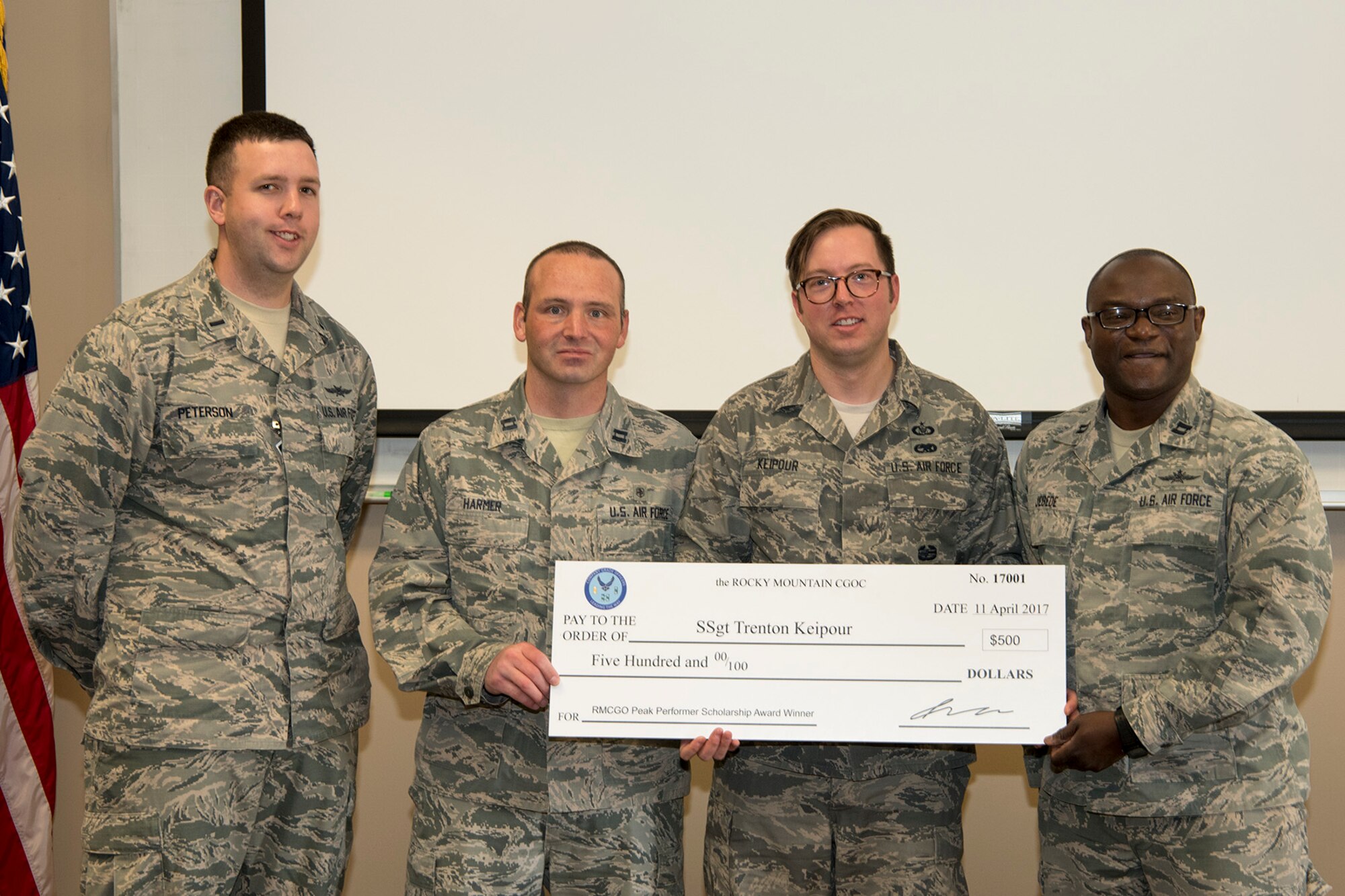 Staff Sgt. Trenton Keipour (third from left), 13th Air Support Squadron resource advisor tactical air control party specialist, is presented with a $500 scholarship by members of the Rocky Mountain Company Grade Officer Council at Fort Carson, Colo., April 17, 2017. The scholarship was awarded by the council to an Airman who is working towards an educational goal that will give them skills in leading tomorrow’s Air Force. Keipour was awarded the scholarship to help with tuition while he works on his master’s of divinity with plans to become a chaplain. (U.S. Air Force photo by Steve Kotecki)