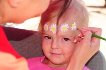 Ani Hugo, 3, gets her face painted during the 924th Fighter Group’s family day at Bama Park on Davis-Monthan Air Force Base, Tucson, Ariz.,.  Along with face painting the children got to jump in bouncy castles, eat snow cones, and dance. (U.S. Air Force photo by Tech. Sgt. Courtney Richardson)