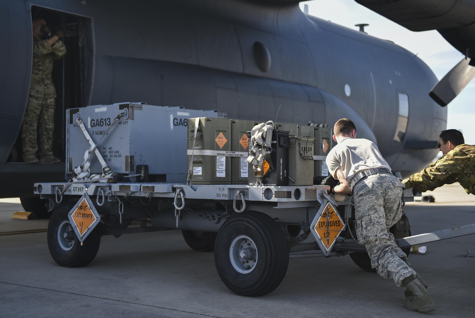 Air Commandos push an ammunition cart to an AC-130U Spooky gunship at Hurlburt Field, Fla., April 17, 2017. The AC-130U is equipped with a 25mm Gatling gun, 40mm and 105mm canons, and can take off carrying more than 150,000 pounds of cargo. (U.S. Air Force photo by Airman 1st Class Joseph Pick)