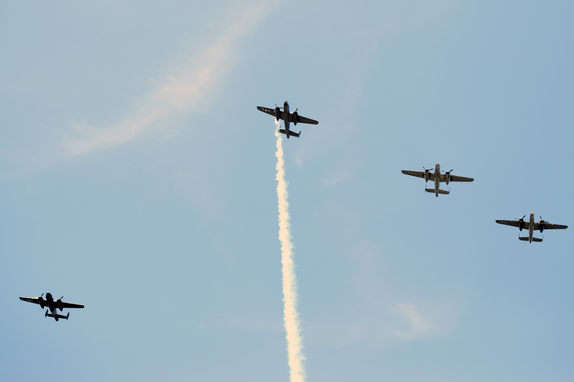 Four B-25 bombers fly the "Missing Man" formation over the Memorial Service honoring the 75th anniversary of the Doolittle Japan Raid on April 18, 1942. The memorial service, held at the National Museum of the United States Air Force April 18, 2017, included two B-25 fly-overs. The first was a typical bomber staggered formation, and included 11 aircraft. The second was the Missing Man formation and honored the 79 members of the original Raiders who have passed. The last living Raider, Lt. Col. Richard Cole, was a participant in the memorial ceremony.  (U.S. Air Force photo/Wesley Farnsworth)