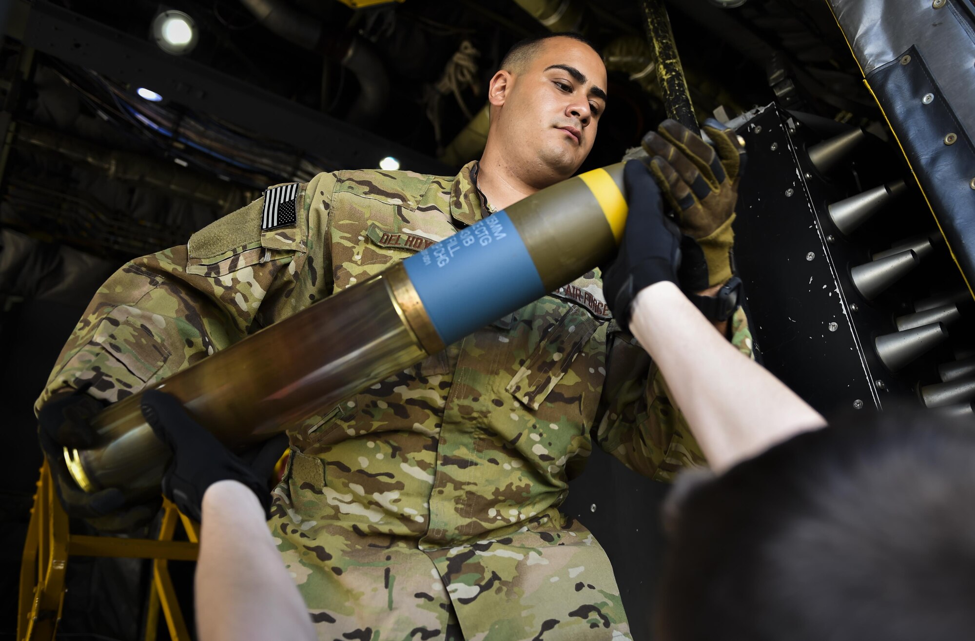 Staff Sgt. Joseph Del Hoyo, a special missions aviator with the 4th Special Operations Squadron, takes control of a 105 mm round at Hurlburt Field, Fla., April 17, 2017. Aircrew with the 4th SOS conducted a live-fire training mission to ensure mission readiness any time, any place. (U.S. Air Force photo by Airman 1st Class Joseph Pick)