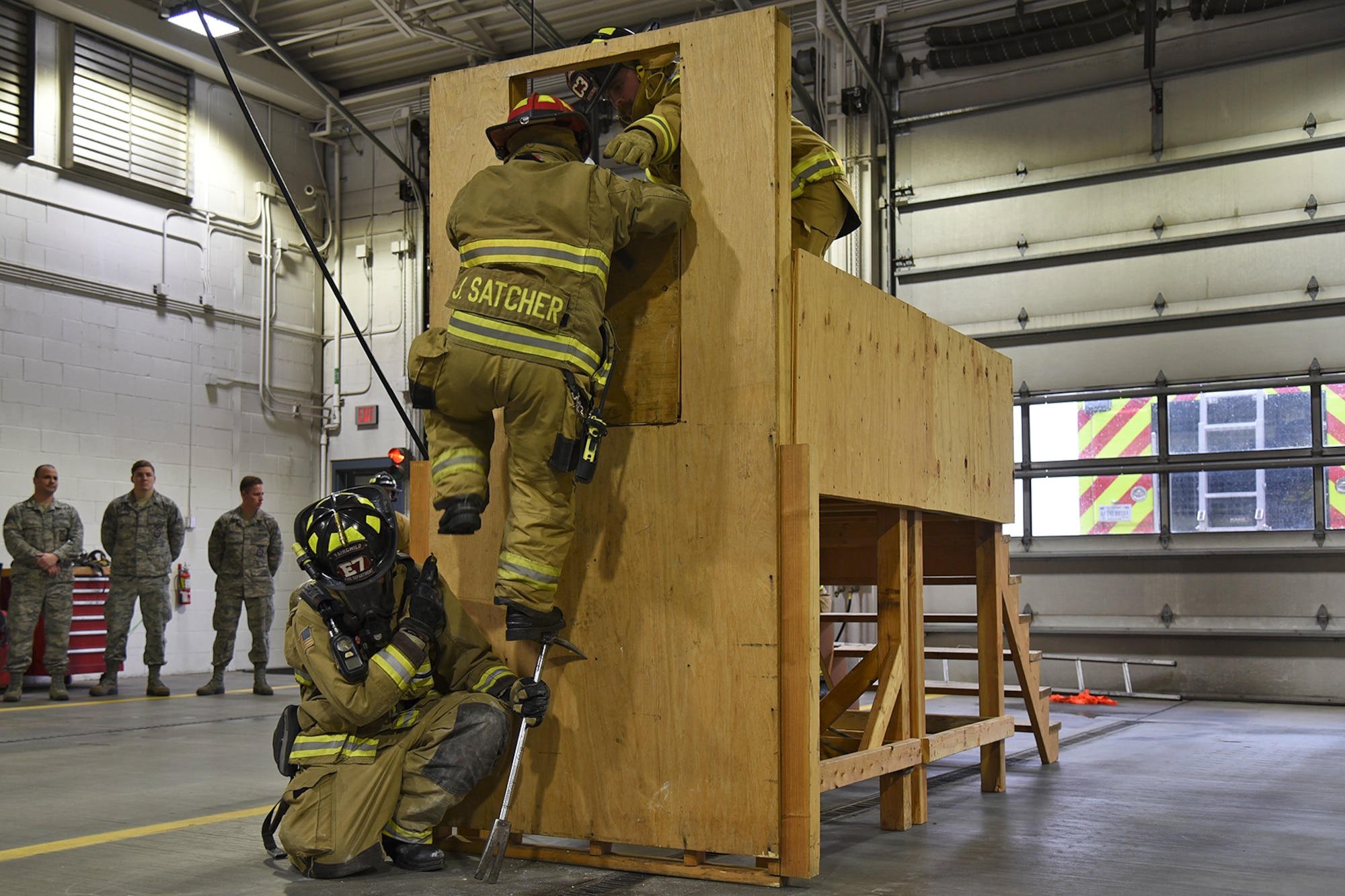 92nd Civil Engineer Squadron firefighters complete the last step of the Rapid Intervention Crew training course Mar. 29, 2017, at Fairchild Air Force Base, Washington. The team must work together to safely rescue and evacuate fellow firefighters who are injured or lost within a structure fire. (U.S. Air Force photo/Senior Airman Mackenzie Richardson)