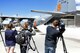 Members of the news media capture video footage as a U.S. Forest Service Modular Airborne Fire Fighting System discharges water during the 302nd Airlift Wing’s MAFFS wet-fire test at Peterson Air Force Base, Colo., April 18. Members of the news media were invited here to witness the Air Force Reservist’s preparations for the upcoming annual U.S. Forest Service MAFFS certification and recertification training event in Boise, Idaho. (U.S. Air Force photo/Daniel Butterfield)