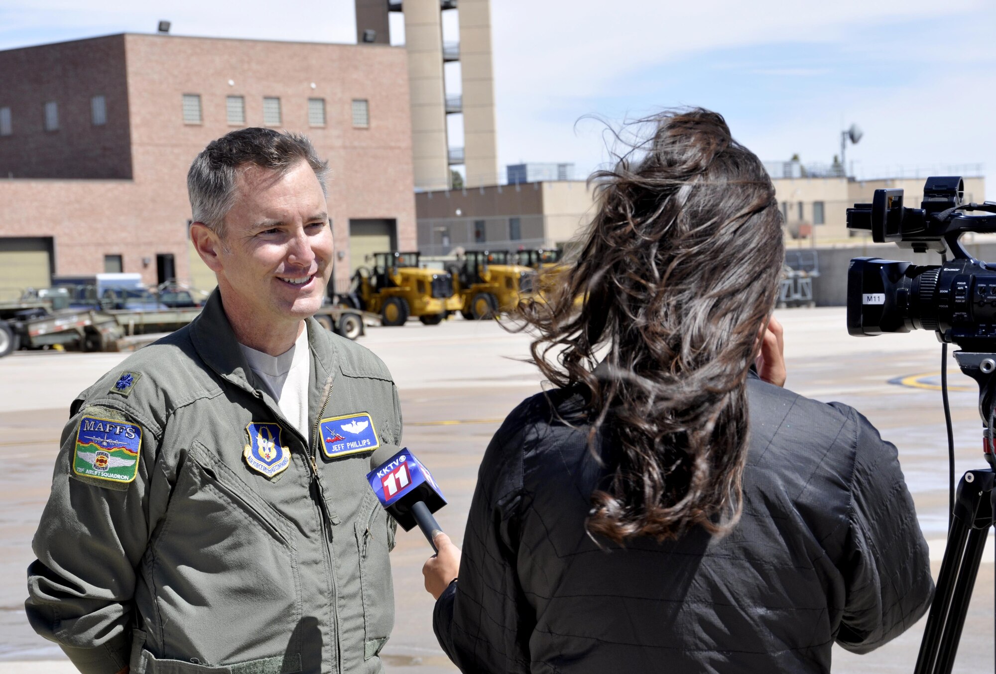 Lt. Col. Jeff Phillips, a Modular Airborne Fire Fighting System-qualified C-130 pilot with the 731st Airlift Squadron, speaks to a television news reporter during the 302nd Airlift Wing’s MAFFS discharge test at Peterson Air Force Base, Colo., April 18. Members of the news media were invited here to witness the Air Force Reservist’s preparations for the upcoming annual U.S. Forest Service MAFFS certification and recertification training event in Boise, Idaho. (U.S. Air Force photo/Staff Sgt. Frank Casciotta)