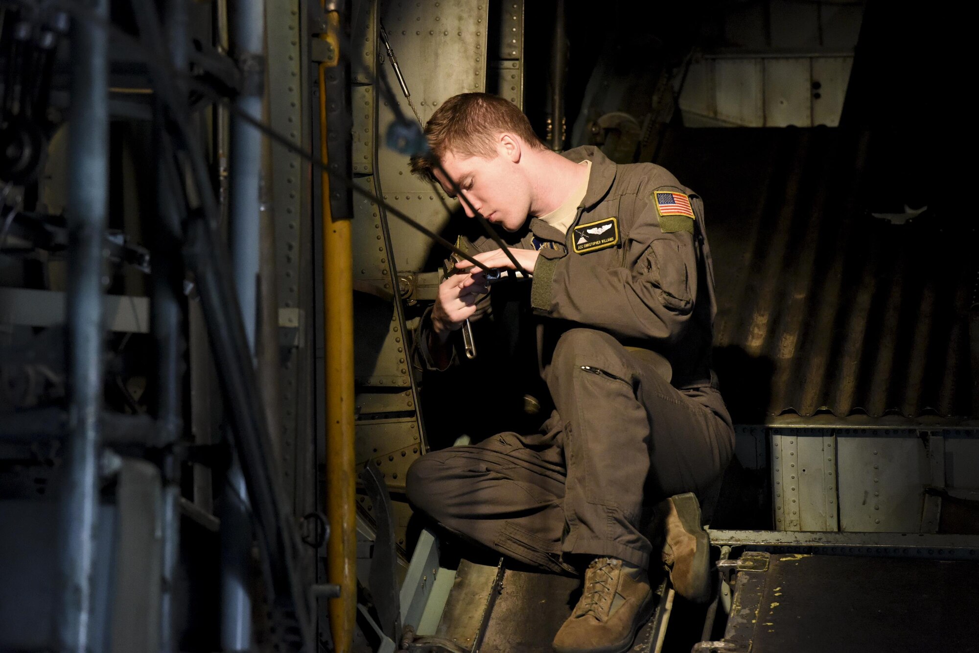 Airman 1st Class Christian Williams, 36th Airlift Squadron loadmaster, performs preflight checks on a C-130 Hercules before takeoff for a personnel drop training exercise on
April13, 2017, at Yokota Air Base, Japan. The personnel drops were a part of Survival, Evasion, Resistance and Escape working group to remain current and proficient (U.S.
Air Force photo by Machiko Arita)
