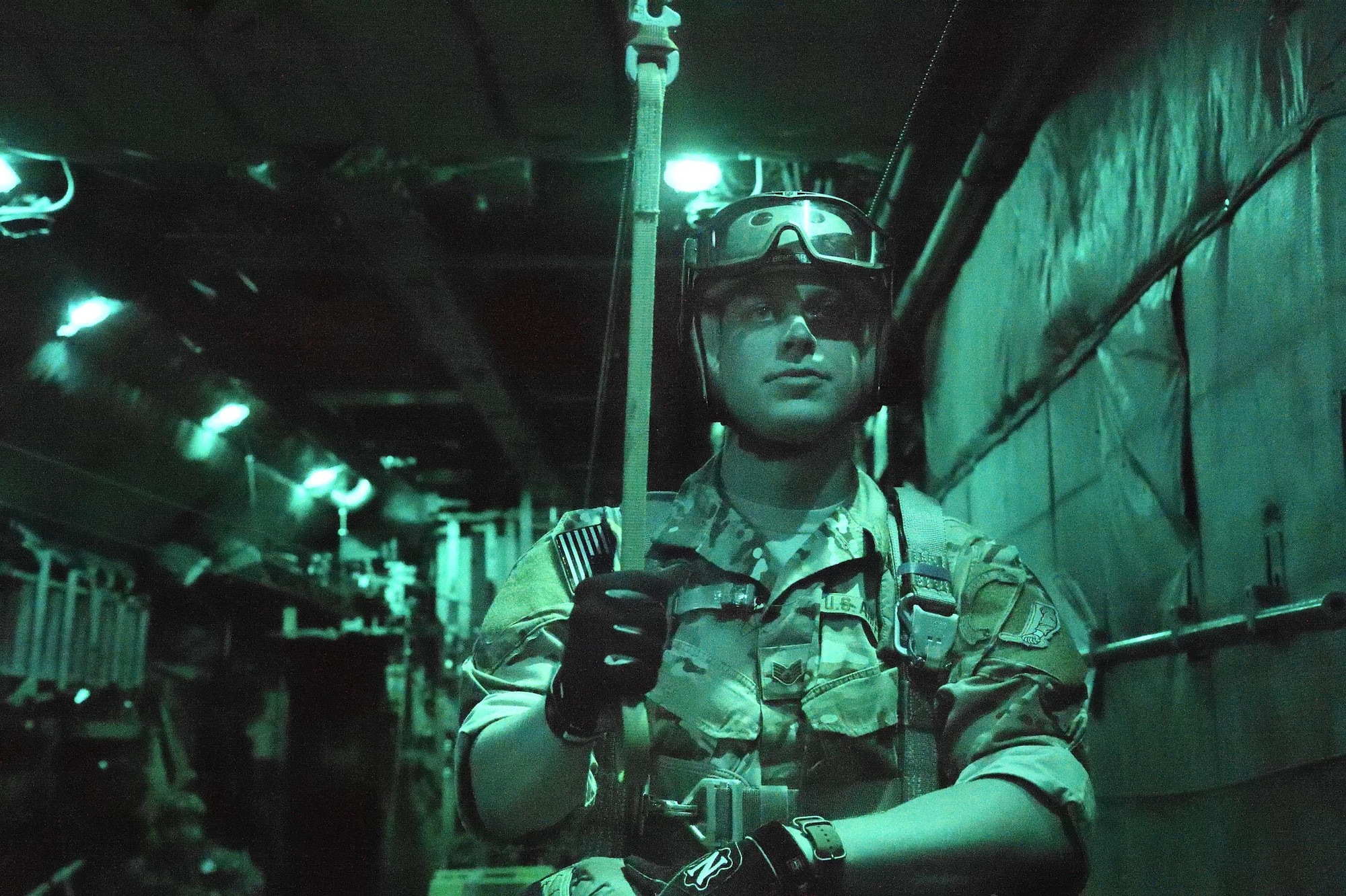 Staff Sgt. Justin Bender, 374th Operations Support Squadron Survival, Evasion, Resistance and Escape training NCO in charge, waits to perform a static line jump on
April 13, 2017, at Yokota Air Base, Japan. SERE is a program created to train aircrew how to survive on their own in any environment under any condition, in the event their
aircraft goes down. (U.S. Air Force photo by Machiko Arita)