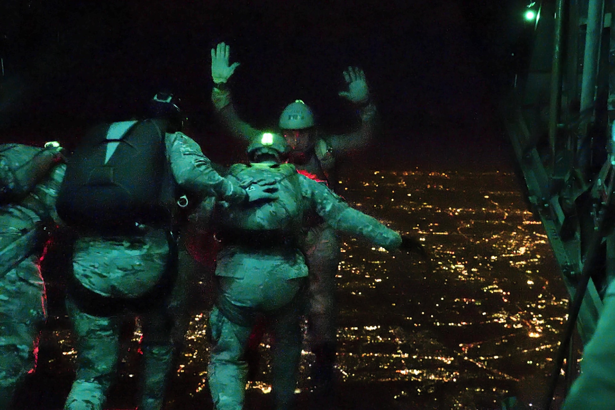A member of Air Force Special Operations, Survival, Evasion, Resistance and Escape specialists jumps out of a C-130 Hercules while flying over Yokota Air Base, Japan,
April 13, 2017. They performed a high altitude low opening parachute drop. (U.S. Air Force photo by Machiko Arita)
