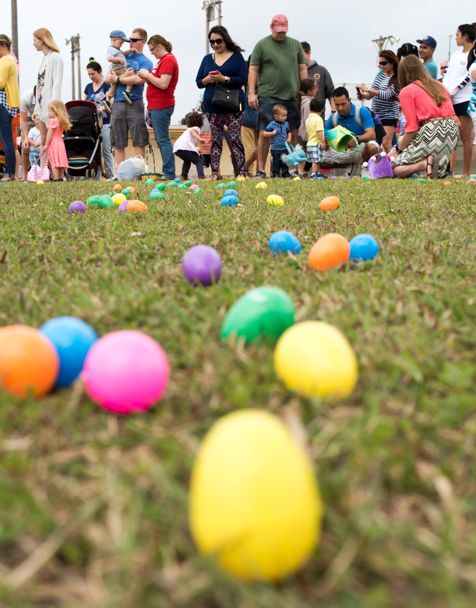 Parents prepare their children to collect Easter eggs scattered on the Four Diamonds softball field April 15, 2017, at Kadena Air Base, Japan. The Eggsplosion, an annual event hosted by the 18th Force Support Squadron, is held annually the day before Easter Sunday. (U.S. Air Force photo by Senior Airman Omari Bernard/Released)