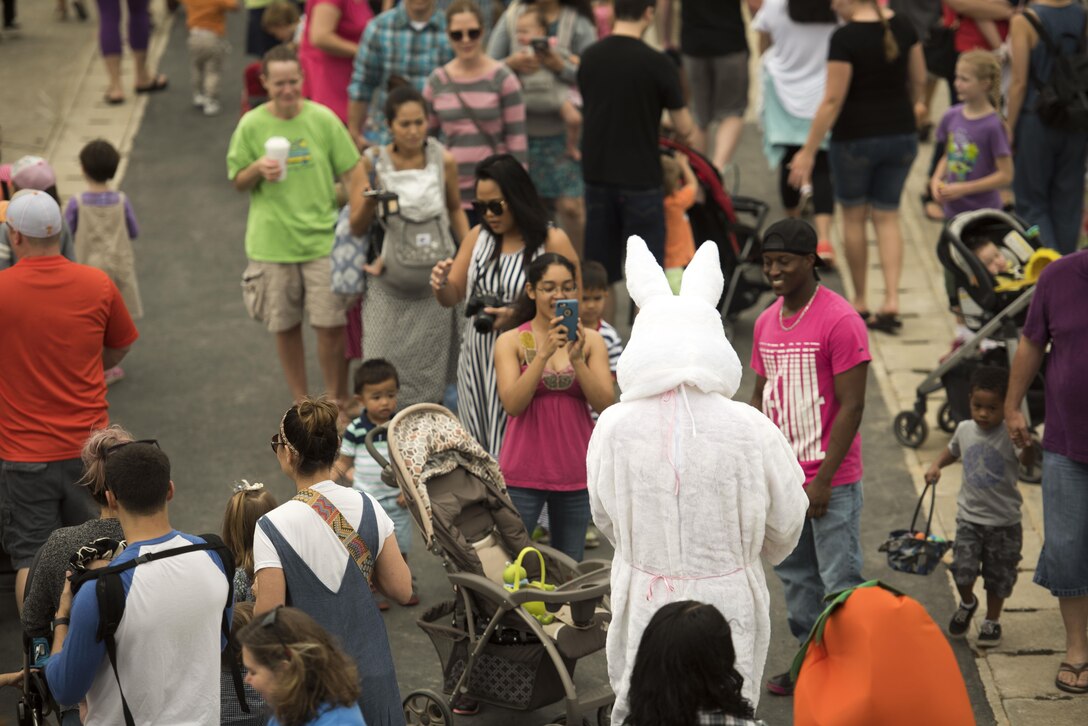 Crowds of families surround an Easter Rabbit for photos during Eggsplosion April 15, 2017, at Kadena Air Base, Japan. Several volunteers dressed up as action heroes, rabbits and carrots during the event. (U.S. Air Force photo by Senior Airman Omari Bernard/Released)