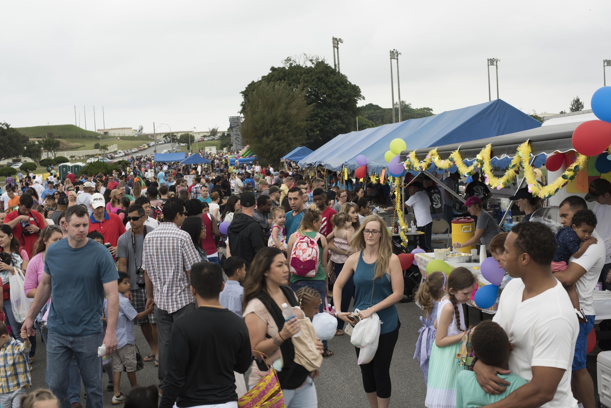 Crowds of service members, civilians, and their families attended Eggsplosion April 15, 2017, at Kadena Air Base, Japan. The 18th Force Support Squadron hosts Eggsplosion annually to raise morale and support Team Kadena’s service members and their families. (U.S. Air Force photo by Senior Airman Omari Bernard/Released)