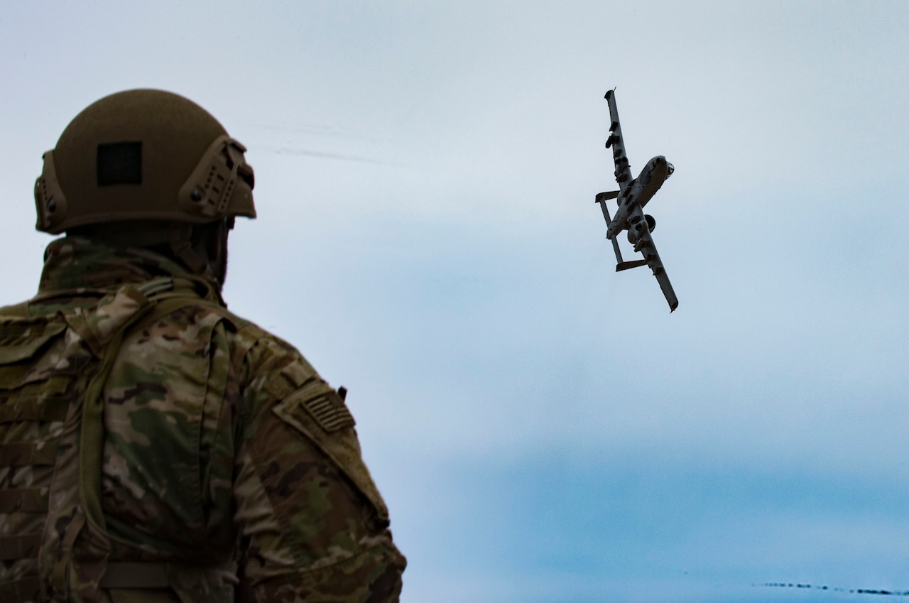 U.S. Air Force Airman 1st Class Diante Cooper, 19th Air Support Operations Squadron Tactical Air Control Party specialist, watches and communicates with an A-10C Thunderbolt II during a joint close air support exercise at Camp Grayling, Mich. April 13, 2017. To further build interoperability and hone their unique skillset, members of the German air force Air Ground Operations Squadron travelled to the U.S. to partner with the 19th ASOS and conduct a close air support exercise working with A-10C Thunderbolts IIs and F-16 Fighting Falcons. (U.S. Air Force photo by Airman 1st Class Daniel Snider)