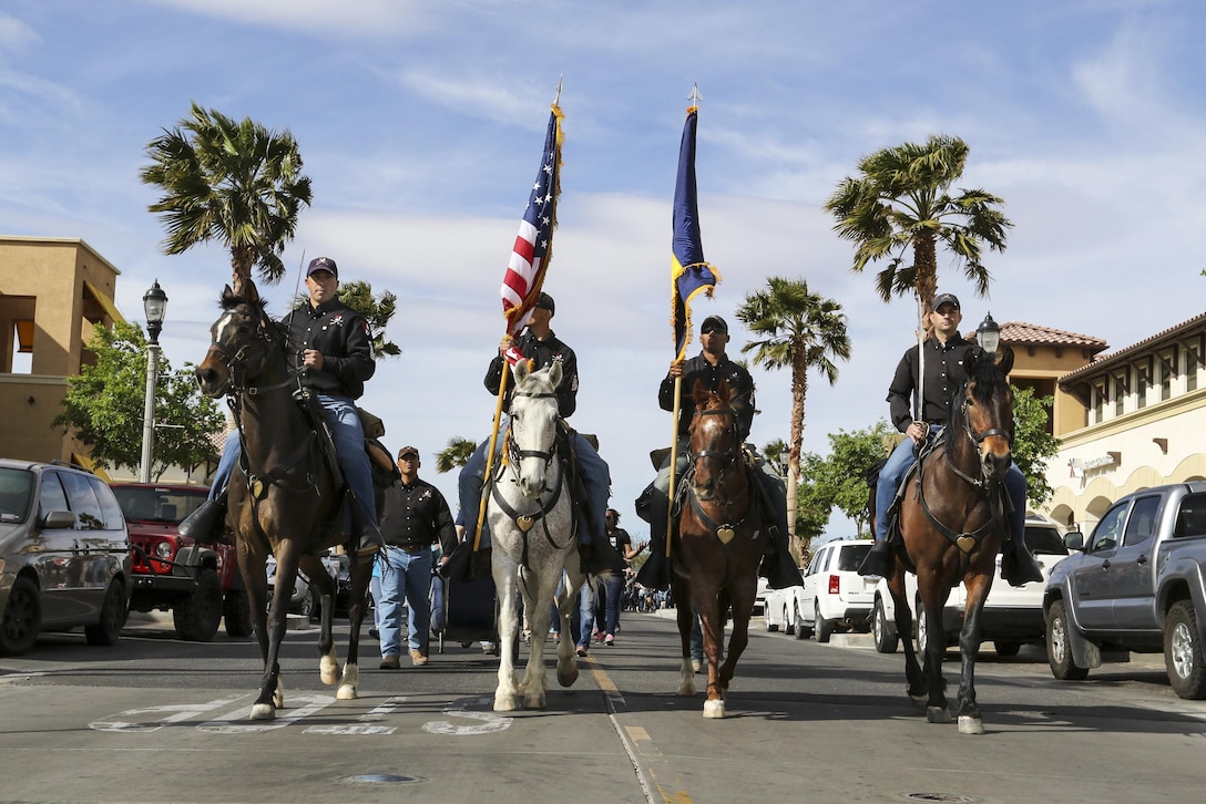 Mounted soldiers ride horses during the 5th annual Denim Day walk at Fort Irwin, Calif., April 17, 2017. Denim Day is an international campaign promoting awareness of sexual assault and harassment. More than 3,000 Fort Irwin soldiers, family members and civilians wore denim jeans and teal-colored shirts as symbols to oppose sexual assault and harassment. Army photo by Pfc. Austin Anyzeski 
