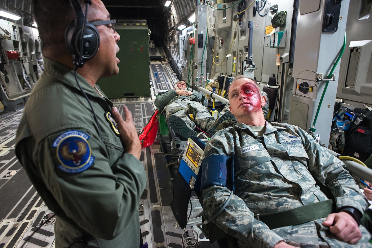 Tech. Sgt. Angel Delacruz, 146th Aeromedical Evacuation Squadron technician, provides simulated medical treatment to Senior Airman Zachary Hart, a volunteer simulated patient, on a C-17 Globemaster III during the Multiple Aircraft Training Opportunity Program (MATOP) organized by the 137th Aeromedical Evacuation Squadron from Will Rogers Air National Guard Base, Oklahoma City, April 7, 2017. Airmen of the 137 AES were joined by eight of the nine Air National Guard aeromedical evacuation squadrons as they hosted the annual training event and accomplished mandatory annual aeromedical training requirements.(U.S. Air National Guard photo by Senior Master Sgt. Andrew M. LaMoreaux/Released)
