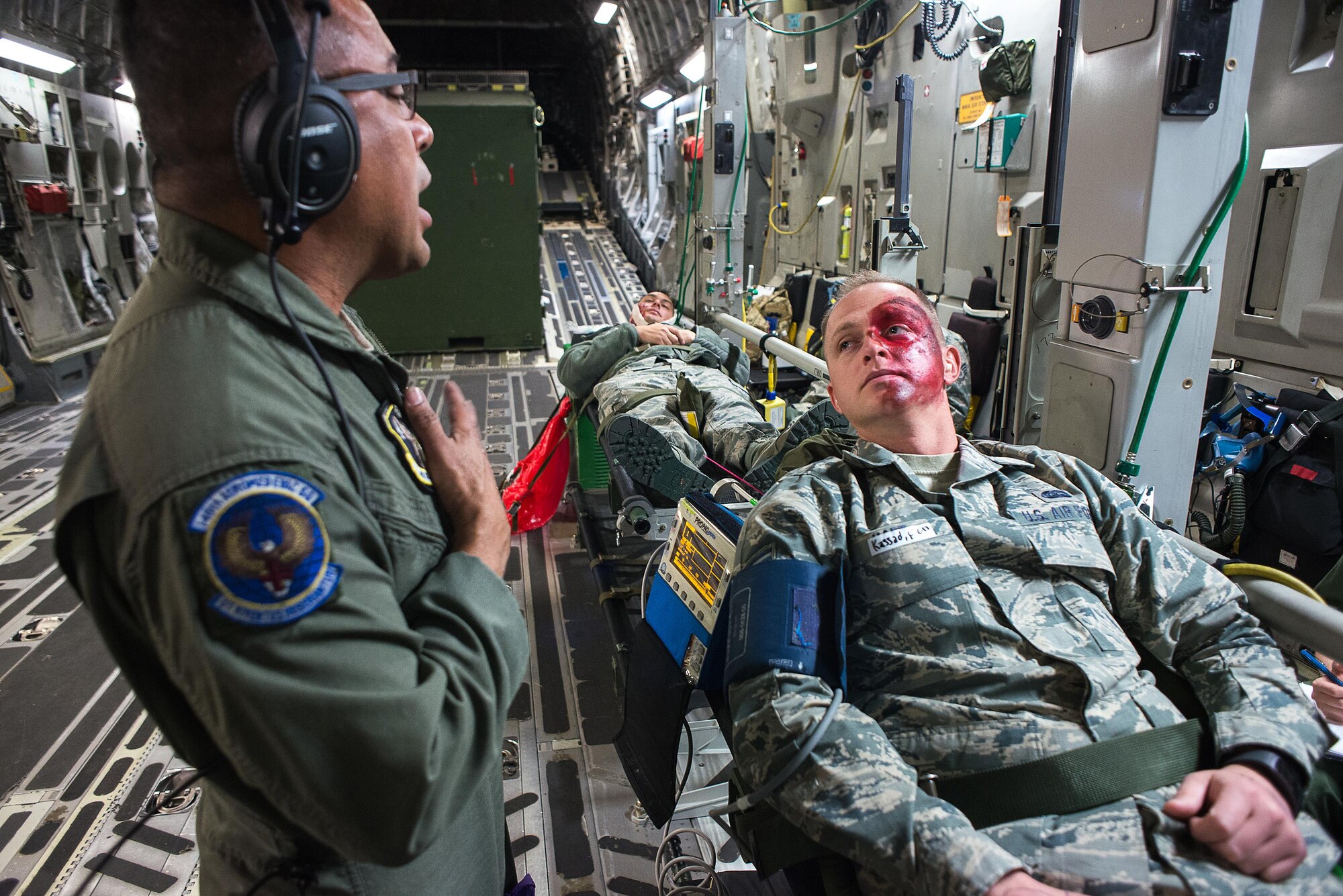 Tech. Sgt. Angel Delacruz, 146th Aeromedical Evacuation Squadron technician, provides simulated medical treatment to Senior Airman Zachary Hart, a volunteer simulated patient, on a C-17 Globemaster III during the Multiple Aircraft Training Opportunity Program (MATOP) organized by the 137th Aeromedical Evacuation Squadron from Will Rogers Air National Guard Base, Oklahoma City, April 7, 2017. Airmen of the 137 AES were joined by eight of the nine Air National Guard aeromedical evacuation squadrons as they hosted the annual training event and accomplished mandatory annual aeromedical training requirements.(U.S. Air National Guard photo by Senior Master Sgt. Andrew M. LaMoreaux/Released)