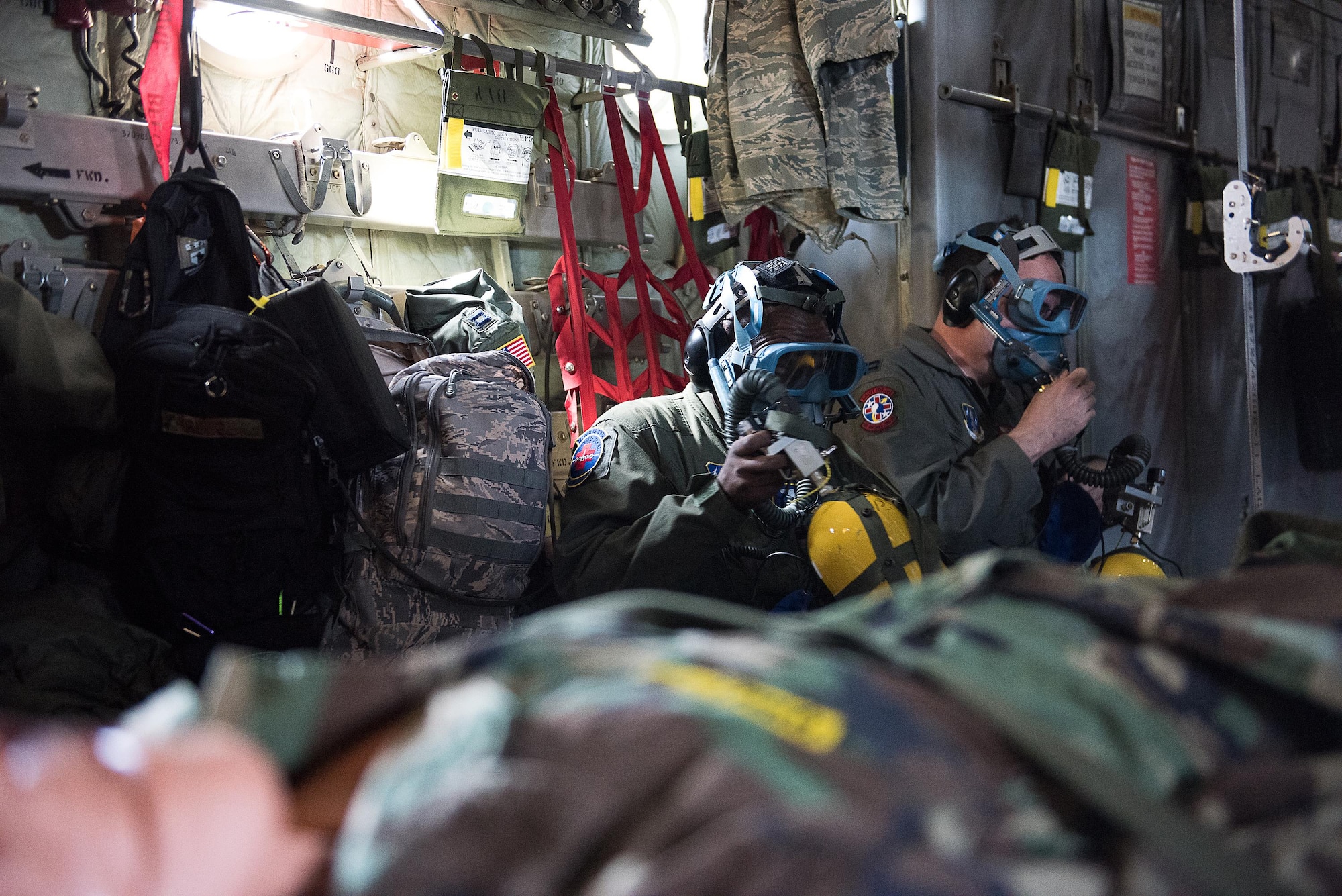Senior Airman Peter Irungu from the 142nd Aeromedical Evacuation Squadron, Delaware Air National Guard, and Capt. Daniel Zico, 137 AES, Oklahoma Air National Guard, don oxygen masks during a simulated fire aboard a C-130 Hercules during the Multiple Aircraft Training Opportunity Program (MATOP) organized by the 137th Aeromedical Evacuation Squadron from Will Rogers Air National Guard Base, Oklahoma City, April 7, 2017. Airmen of the 137 AES were joined by eight of the nine Air National Guard aeromedical evacuation squadrons as they hosted the annual training event and accomplished mandatory annual aeromedical training requirements. (U.S. Air National Guard photo by Capt. Micah D. Campbell/Released)