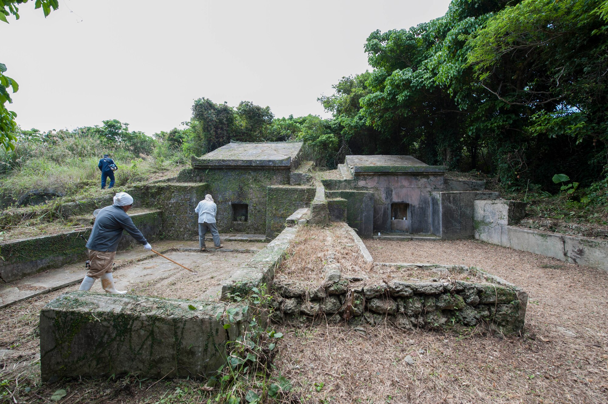 Local Okinawans finish clearing away the vegetation on ancestral tombs April 9, 2017, at Kadena Air Base, Japan. Families will visit the tombs at least once a year to maintain the tombs and pay their respects to their deceased family members. (U.S. Air Force photo by Airman 1st Class Quay Drawdy)