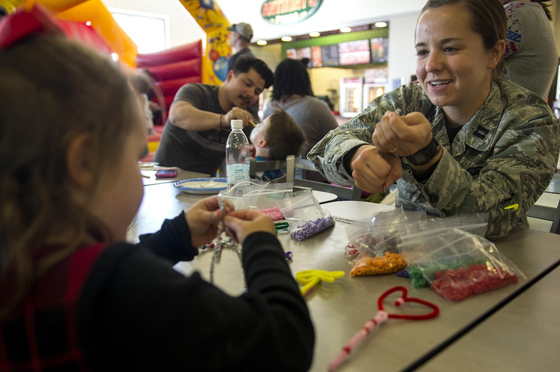Capt. Katelin Shipp, 52nd Force Support Squadron protocol officer, demonstrates how to make a decorative star during the fourth annual Spring Fling event in the Base Exchange at Spangdahlem Air Base, Germany, April 14, 2017. The event was held to bring awareness to the Exceptional Family Member Program and included various activities for children such as face painting, craft making, a bouncing castle and boat races. (U.S. Air Force photo by Airman 1st Class Preston Cherry)