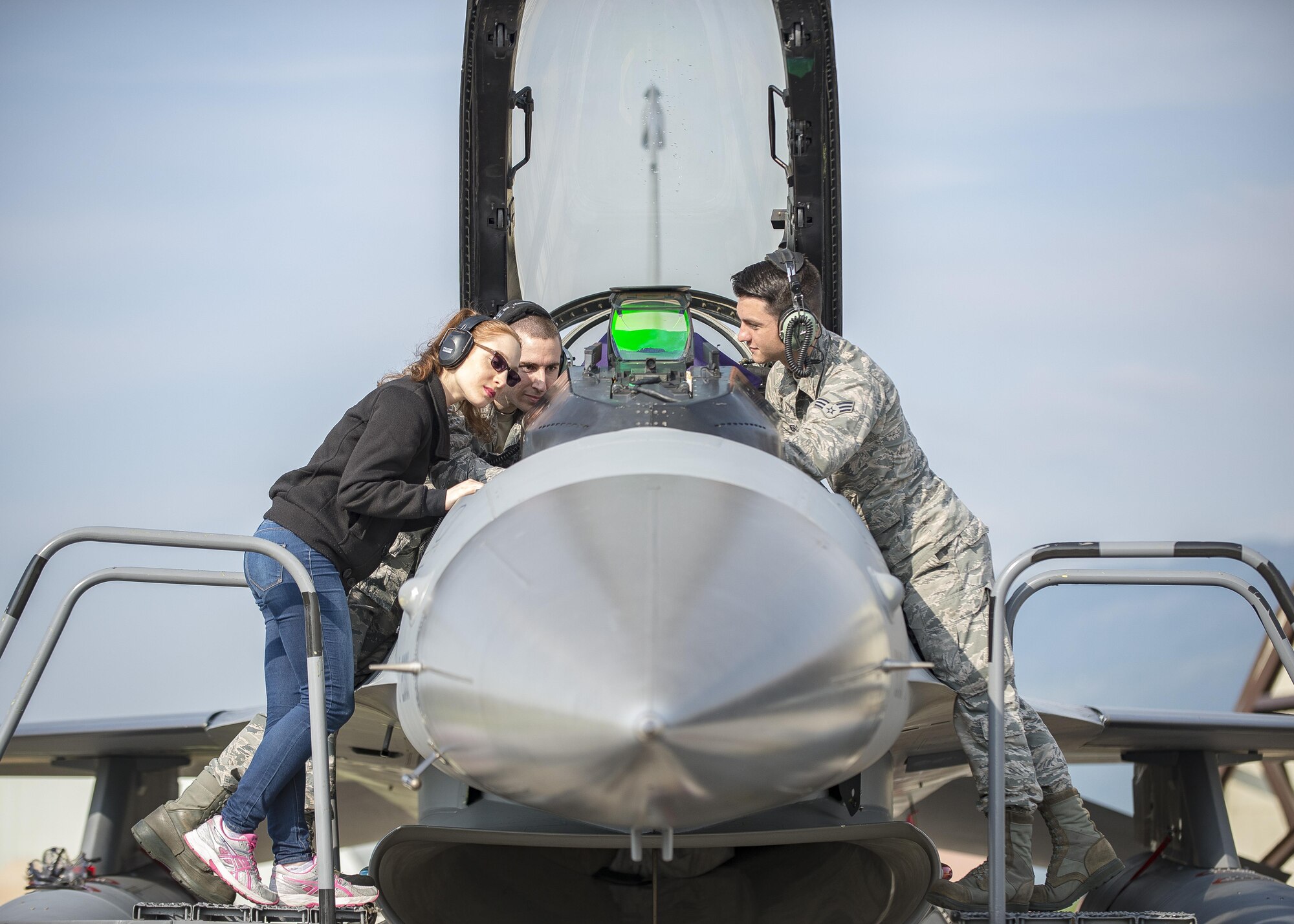 Senior Airmen Evan Stills and Kent Romero, 31st Aircraft Maintenance Squadron avionics technicians, show Mariagrazia De Iudicibus, 31st AMXS spouse, the functionality of an F-16 Fighting Falcon cockpit during a Spouses’ Appreciation Day event at Aviano Air Base, Italy, April 12, 2017. The day’s events consisted of a squadron tour, multiple demonstrations of tasks and the ability to perform those tasks 31st AMXS Airmen perform on a day-to-day basis. (U.S. Air Force photo by Senior Airman Cory W. Bush)