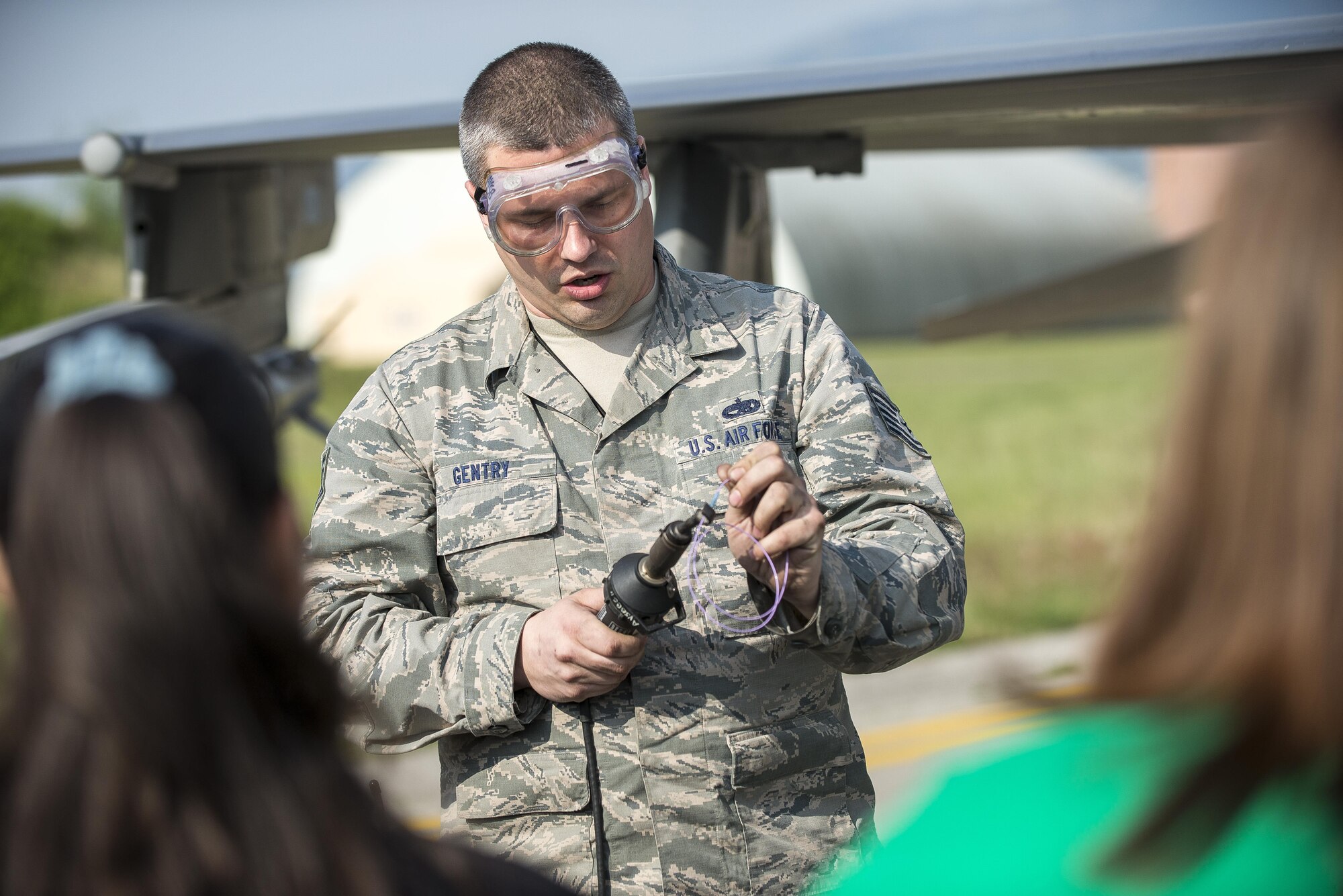 Tech Sgt. Christopher Gentry, 31st Aircraft Maintenance Squadron electrical and environmental systems lead technician, demonstrates cable maintenance techniques during a Spouses’ Appreciation Day event at Aviano Air Base, Italy, April 12, 2017. The spouses were put to the test shortly after learning this technique by performing maintenance on an F-16 Fighting Falcon. (U.S. Air Force photo by Senior Airman Cory W. Bush)