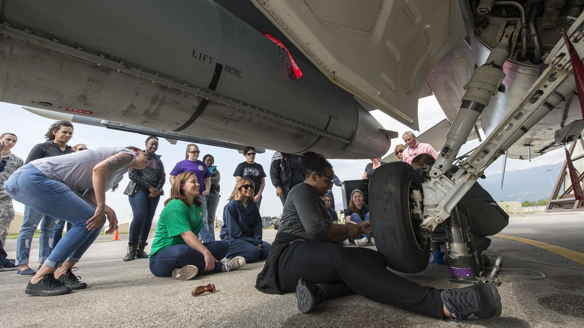 31st Aircraft Maintenance Squadron spouses participated in a Spouses Appreciation Day at Aviano Air Base, Italy, April 12, 2017. To have the full maintainer experience, spouses donned their own rubber gloves and steel-toed boots, pushed tool boxes out to the flightline and got straight to fixing jets. (U.S. Air Force photo by Senior Airman Cory W. Bush)
