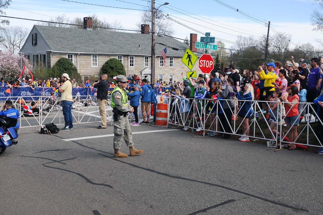 Massachusetts Army National Guard Spc. Brandon Teixeira provides security near the starting line as hand cyclers begin the 121st Boston Marathon in Hopkinton, Mass., April 17, 2017. Brandon is a military police officer assigned to the Massachusetts Army National Guard’s 747th Military Police Company. About 500 Massachusetts National Guard soldiers and airmen and guardsmen from 20 other states assisted law enforcement agencies. Army National Guard photo by Sgt. Michael V. Broughey 