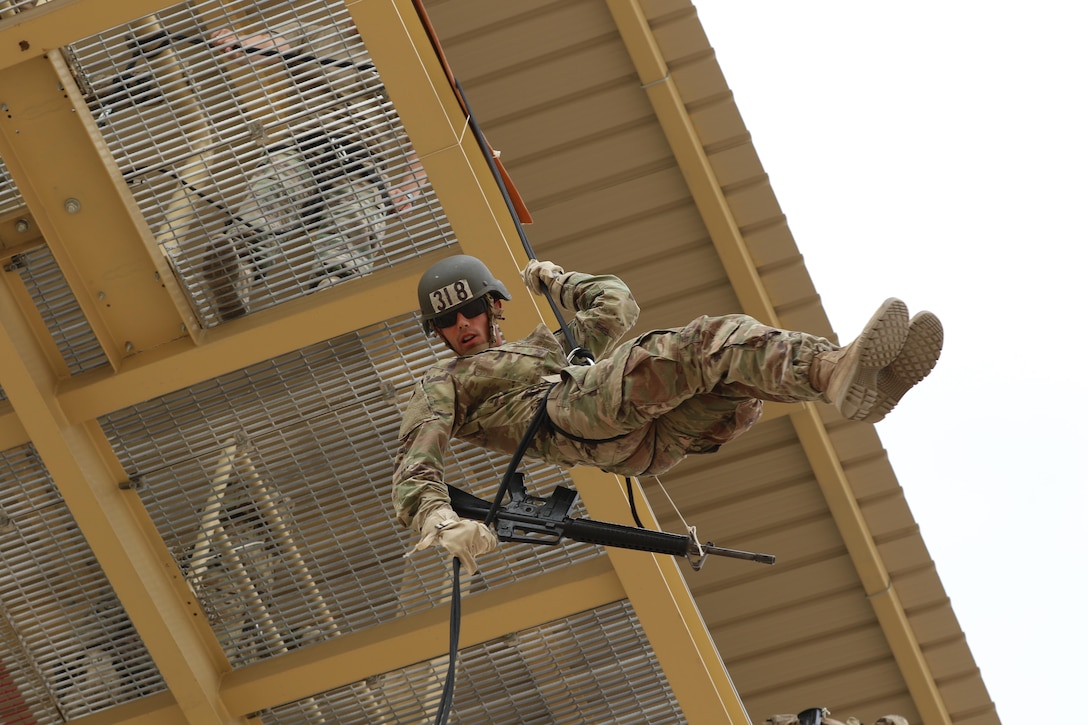 U.S. Army Spc. Dylan Gustaitis, radiology specialist, 215th Brigade Support Battalion, 3rd Armored Brigade Combat Team, 1st Cavalry Division, rappels off a tower at Kuwait’s first Air Assault Course, April 12, 2017, at Camp Buehring, Kuwait. Rappelling off a 50-foot tower is one of several tests students have to pass within in the three phases of the course. The Air Assault Course is a 12-day class that allows U.S. military personnel in the U.S. Army Central area of operations the unique opportunity to become air assault qualified, while deployed outside the continental United States.