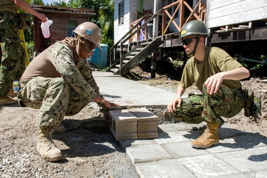 Navy Petty Officer 2nd Class Remie Acosta and Japanse Self-Defense Force Sgt. Hiroki Ii discuss final stages of the construction project at Binyu Primary School, an engineering site of Pacific Partnership 2017 in Kuching, Malaysia, April 17, 2017. Navy photo by Petty Officer 2nd Class Chelsea Troy Milburn