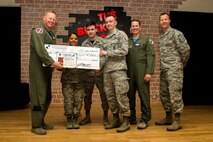 Spangdahlem's leadership team presents 52nd Security Forces Squadron Dorm 335 members with a check for $1,000 and a certificate for winning first place at the Dorm of the Quarter awards held in the Brick House at Spangdahlem Air Base, Germany, April 14, 2017. The funds awarded will go towards improvements and renovations for Dorm 335. (U.S. Air Force photo by Airman 1st Class Preston Cherry)