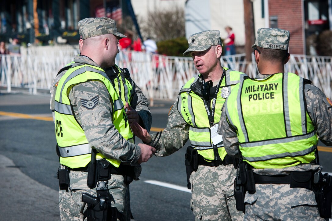 Massachusetts Army and Air National Guardsmen discuss route security procedures before the start of the 121sth Boston Marathon in Hopkinton, Mass., April 17, 2017. Army National Guard photo by Staff Sgt. Evan Lane
