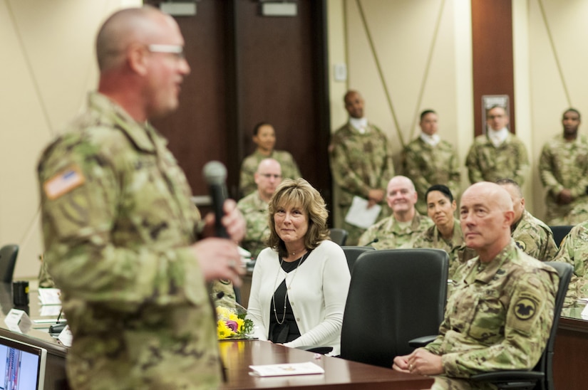 Grace Copeland, seated, listens to her husband, U.S. Army Reserve Command Sgt. Maj. Ted L. Copeland, as he gives his remarks during a change of responsibility ceremony at the U.S. Army Forces Command and U.S. Army Reserve Command headquarters, April 18, 2017, at Fort Bragg, NC. Copeland takes over the U.S. Army Reserve's top enlisted position after serving as the command sergeant major of the 79th Sustainment Support Command in Los Alamitos, Calif. (U.S. Army photo by Timothy L. Hale/Released)