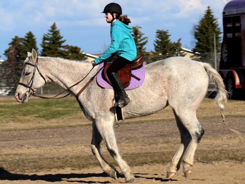 Alyssa Connor, daughter of 91st Missile Wing Commander Col. Colin Connor, rides her horse Sterling at the Dufresne Riding Club Stables at Minot Air Force Base, N.D., April 11, 2017. The Dufresne Riding Club is an inexpensive way for Airmen to keep their horses on base. (U.S. Air Force photo/Airman 1st Class Austin M. Thomas)