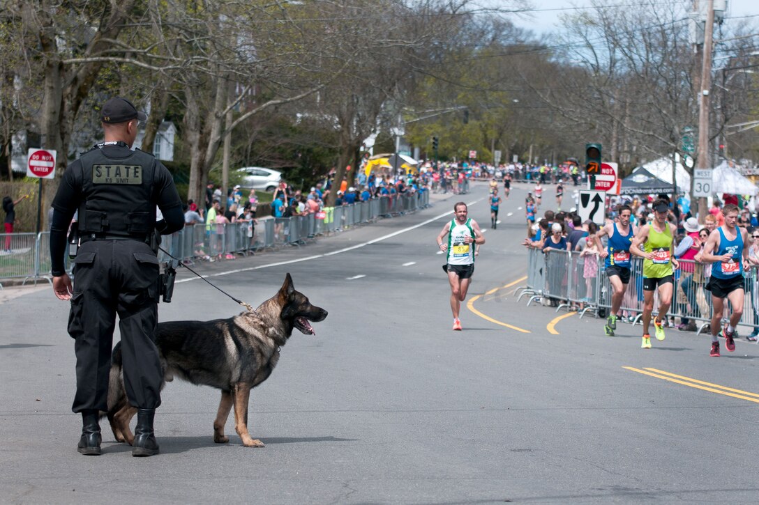 A local law enforcement officer and his police dog provide security during the 121st Boston Marathon in Hopkinton, Mass., April 17, 2017. Army National Guard photo by Staff Sgt. Evan Lane