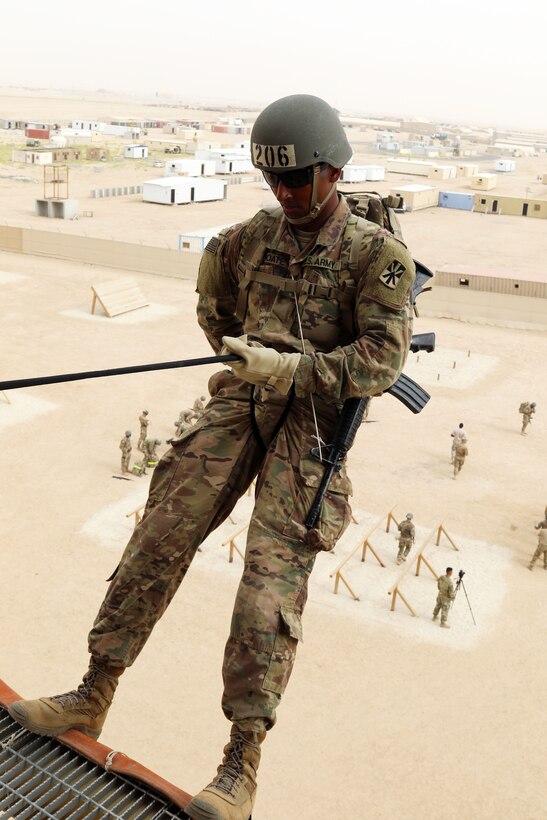 Army Spc. Caleb Choate leans back over the edge of the 50-foot rappel tower during the air assault course at Camp Buehring, Kuwait, April 12, 2017. Army photo by Sgt. Tom Wade