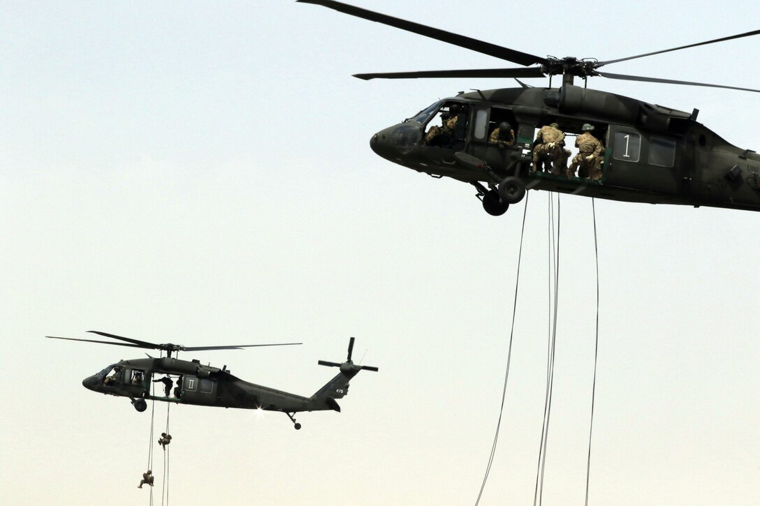 Soldiers rappel from UH-60 Black Hawk helicopters during day nine of the air assault course at Camp Beuhring, Kuwait, April 13, 2017. Army photo by Sgt. Tom Wade