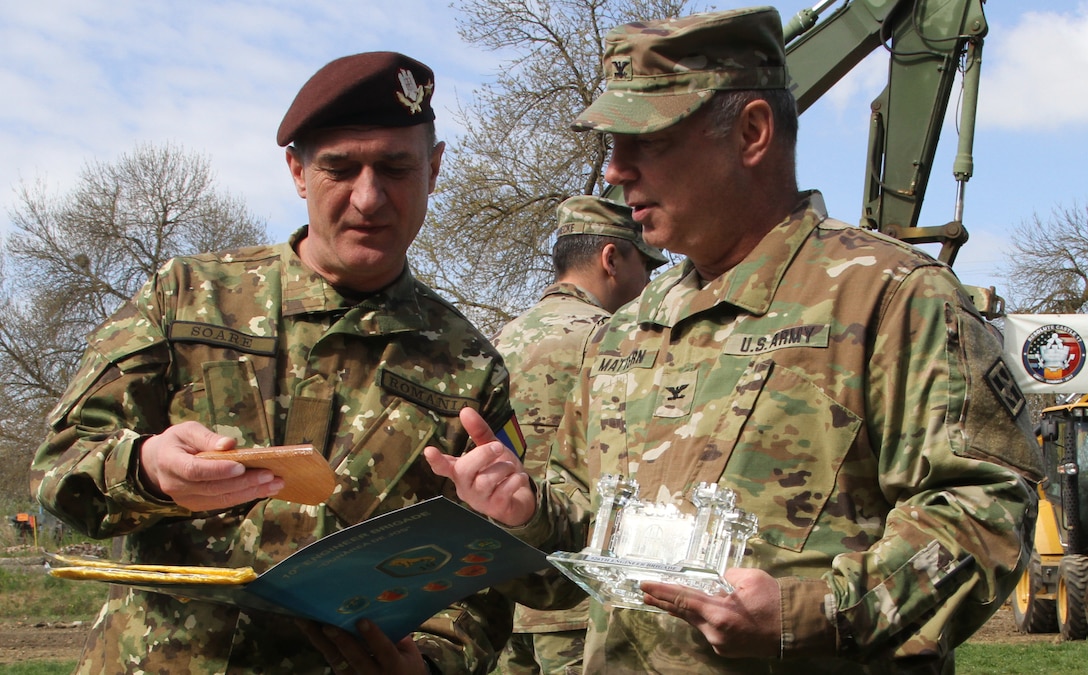 Army Col. Paul Mattern, commander of the 926th Engineer Brigade, and Romanian Land Forces Brig. Gen. Gheorghe Soare, commander of the 10th Engineer Brigade, exchange gifts after the opening ceremony for Resolute Castle 2017 at Cincu Training Center, Romania, April 14, 2017. Army photo by Pvt. Nicholas Vidro