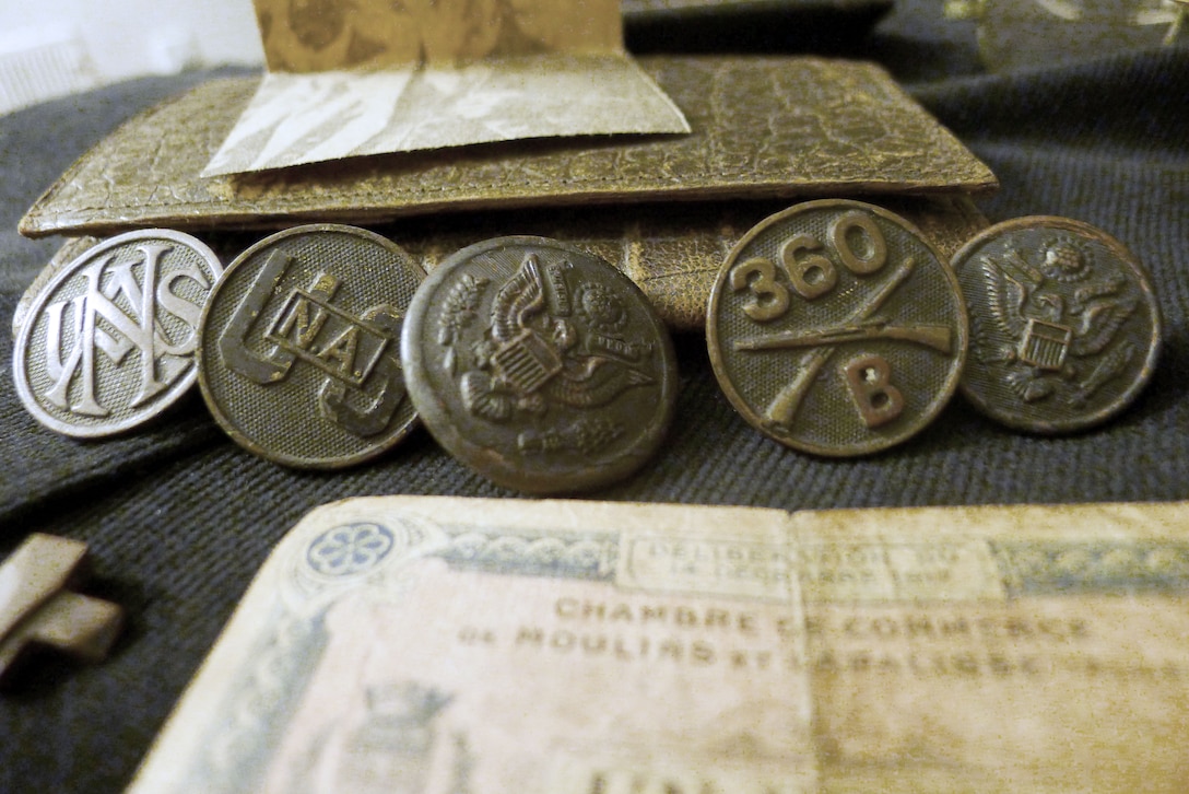 Close-up of uniform buttons, including U.S. National Army.