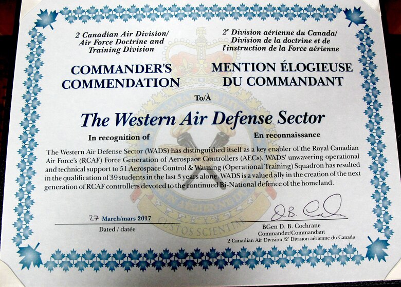The 2nd Canadian Air Division Commander’s Unit Commendation citiation is presented to the Western Air Defense Sector during the Canadian Mess Dinner April 7 for providing critical live and virtual training to Canadian aerospace controllers from the 51 Aerospace Control and Warning (Operational Training) Squadron from North Bay, Ontario.
