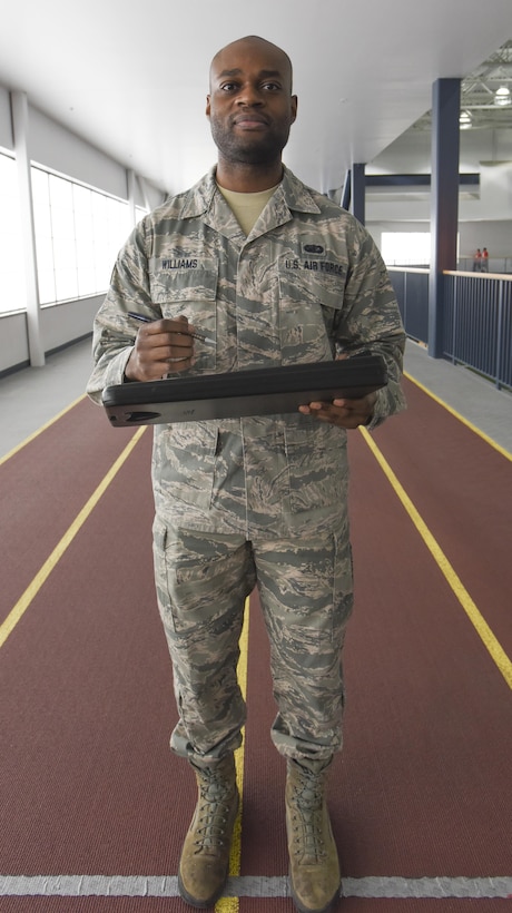 Air Force Staff Sgt. Jean-Paul Williams, 168th Force Support Squadron services craftsman, administers physical fitness tests during monthly training at Baker Field House, Eielson Air Force Base, Alaska, April 2, 2017. As a unit fitness program manager, Williams ensures that airmen are current with their PT tests and implements training plans for those who need extra motivation. Air National Guard photo by Airman 1st Class Mae S. Olson