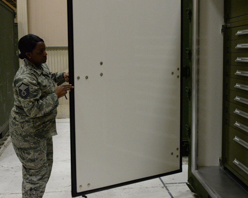 Master Sgt. Jessica Young, aircraft parts store and mobility readiness spares parts section chief assigned to the 28th Logistics Readiness Squadron, opens an Internal Slingable Unit on the flight line at Ellsworth Air Force Base, S.D., April 12, 2017. The 28th LRS received an updated model of the unit on April 10, 2017, which incorporates installed drawers that allow for consumable materials to be transported. (U.S. Air Force photo by Airman Nicolas Z. Erwin)