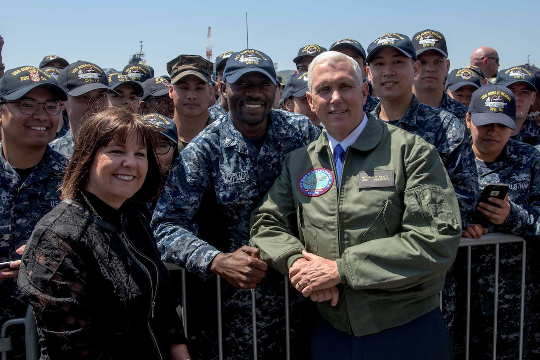 Vice President Mike Pence and his wife, Karen Pence, pose for a photo with service members on the flight deck of the USS Ronald Reagan  in Yokosuka, Japan, April 19, 2017. Navy photo by Petty Officer 2nd Class Nathan Burke
