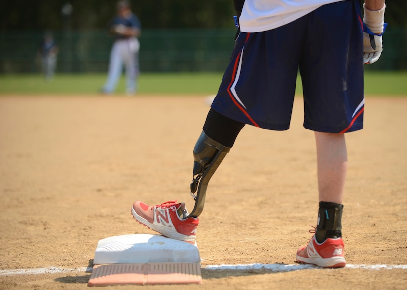 A Wounded Warrior Amputee Softball Team member stands on first base during the WWAST game against the Newport News police and fire departments in Newport News, Va., April 15, 2017. The members’ amputations range from above the knee to below the elbow, and they hope to educate others that “life without limbs is limitless.” (U.S. Air Force photo/Airman 1st Class Kaylee Dubois)