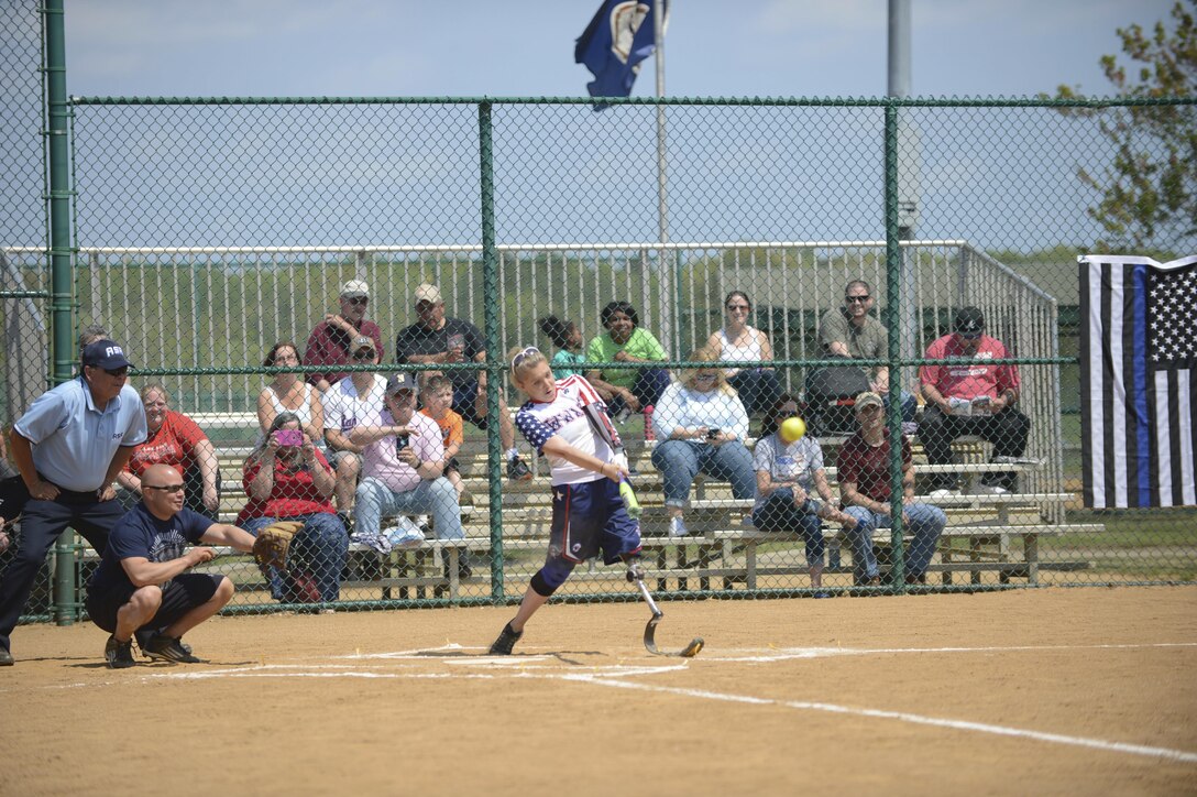 Retired U.S. Air Force Senior Airman Heather Carter, Wounded Warrior Amputee Softball Team member, hits the ball during the WWAST game against the Newport News police and fire departments in Newport News, Va., April 15, 2017. The WWAST athletes play against able-bodied athletes in exhibitions across the country to inspire those who face adversity. (U.S. Air Force photo/Airman 1st Class Kaylee Dubois)