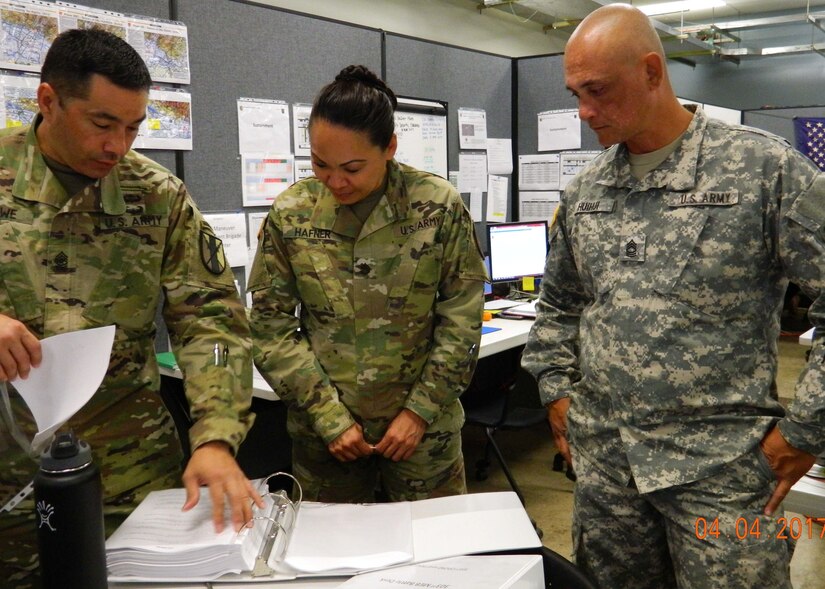 303rd Maneuver Enhancement Brigade Soldiers, review their unit’s standard operating procedures in order to map out their next move during a warfighter exercise (WFX) ) hosted by the 25th Infantry Division at Mission Training Complex – Hawaii, Schofield Barracks, April 4, 2017. The exercise ran from April 3-12. It was the first time the 303rd MEB participated in a WFX since its activation just 4 years ago. As the only MEB in the Pacific region, the WFX enhances training to provide for proficiency in the Brigade’s full mission capabilities on protection and freedom of maneuver within a battle area of operation.
